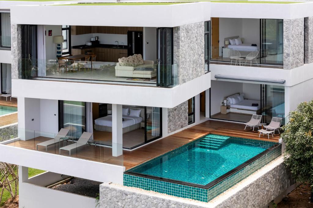 an aerial view of a house with a swimming pool at Villa Serenity Bay, Modern 4-BR Partial Sea View villa in Plai Laem