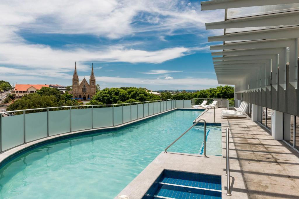 a swimming pool on the roof of a building at Oaks Ipswich Aspire Suites in Ipswich