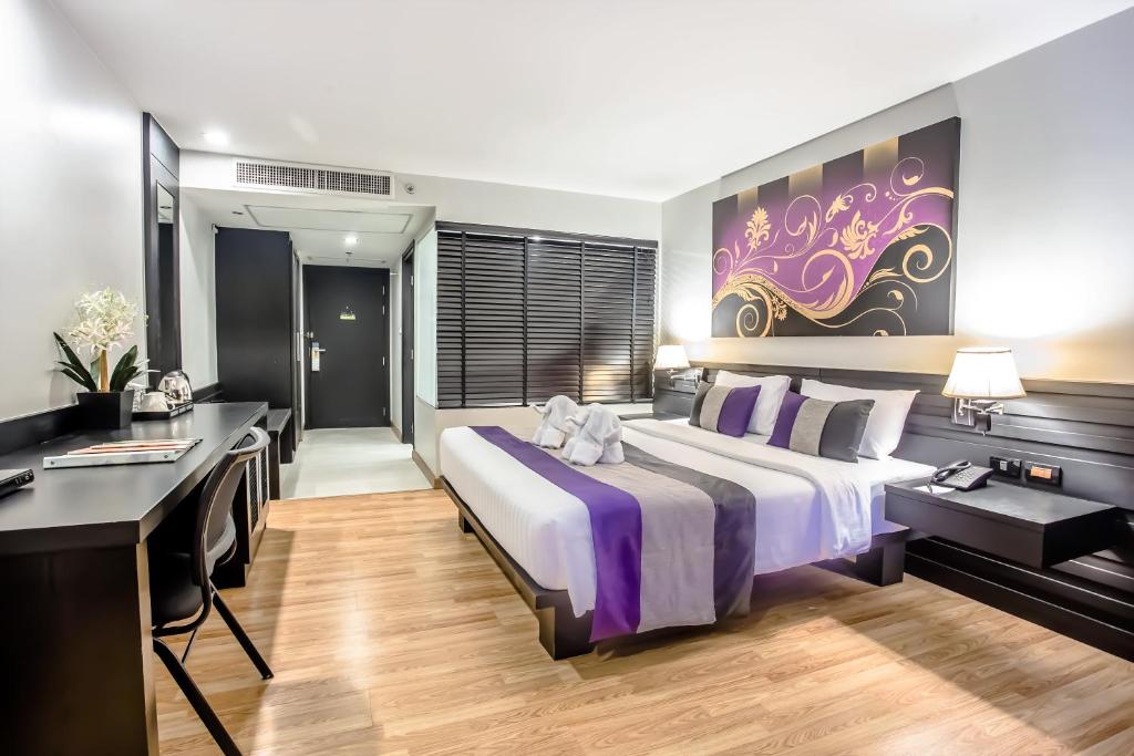 A bedroom with a dedicated desk beside the entry area.