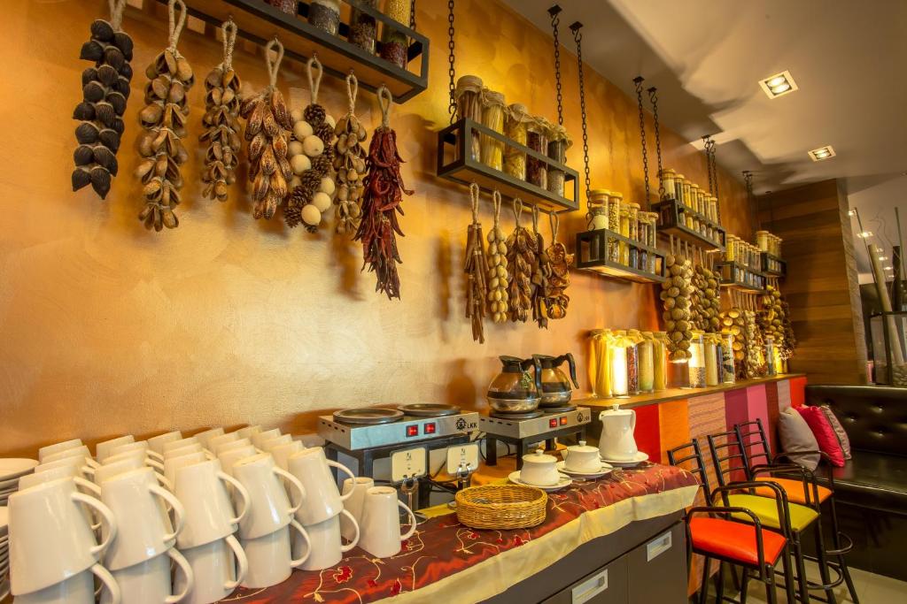 A breakfast service counter with tea, coffee and decorative hanging ingredients.
