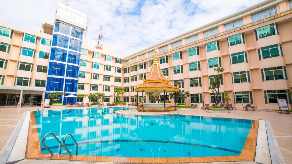 a large building with a swimming pool in front of it at Phnom Penh Hotel in Phnom Penh