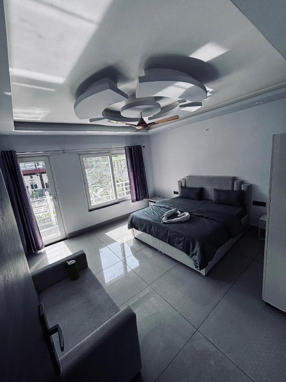 a bedroom with a bed and a ceiling fan at Hotel Amrit Bliss in Rishīkesh