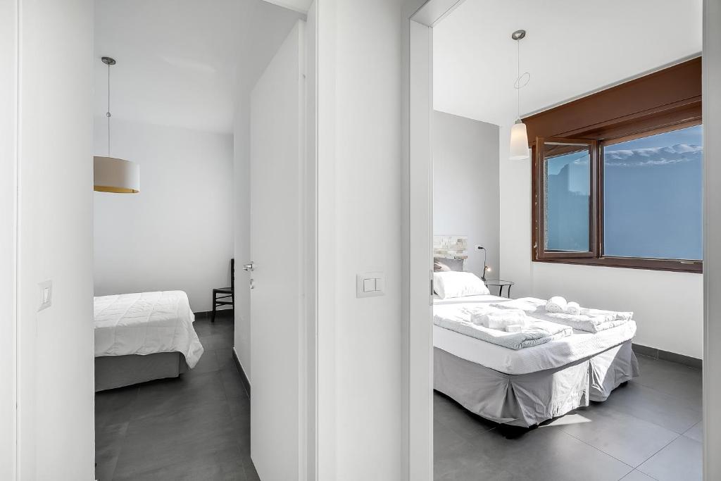 Łóżko lub łóżka w pokoju w obiekcie Casa dei Nonni Apartments