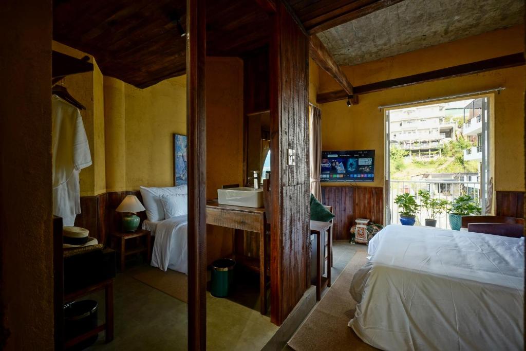 Giường trong phòng chung tại Nexus House An Son Da Lat
