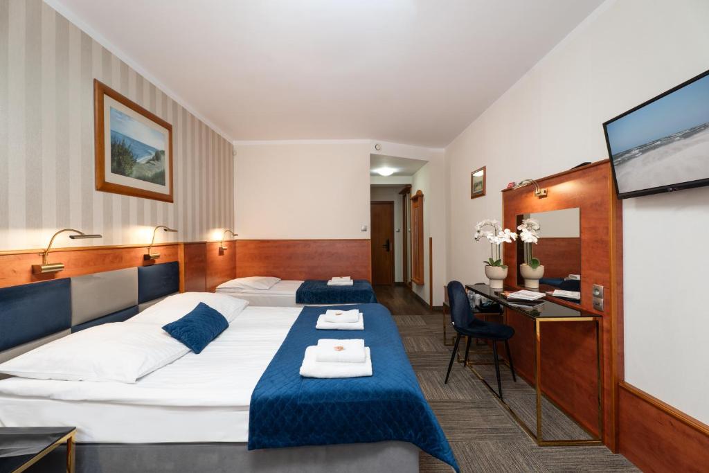 Postel nebo postele na pokoji v ubytování Hotel Rejs