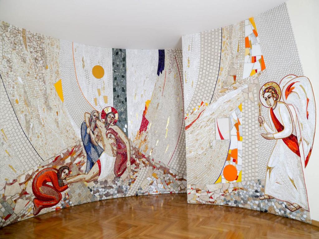 a room with three paintings on the wall at Roma Room Hotel in Rome