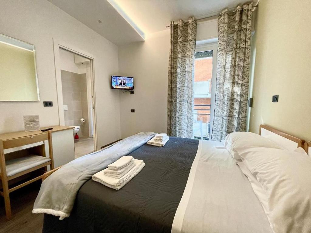 Postel nebo postele na pokoji v ubytování Hotel Quisisana