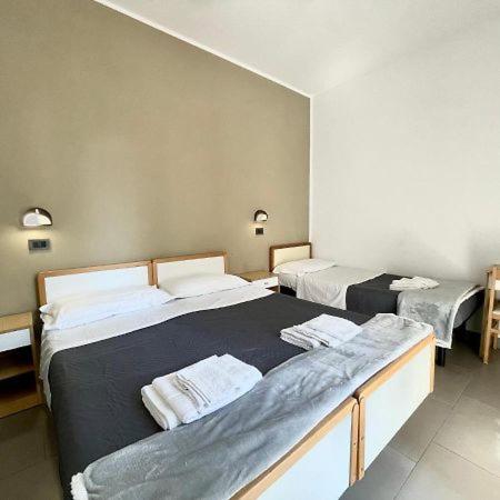 Postel nebo postele na pokoji v ubytování Hotel Quisisana