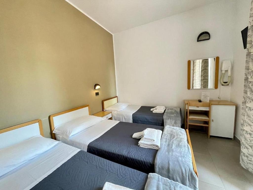 Postel nebo postele na pokoji v ubytování Hotel Quisisana