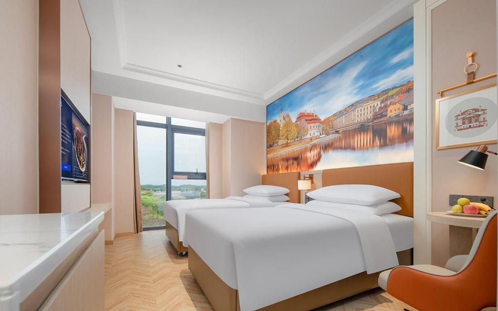 Postel nebo postele na pokoji v ubytování Vienna Hotel Chengdu Tianfu Airport Wanhui Center