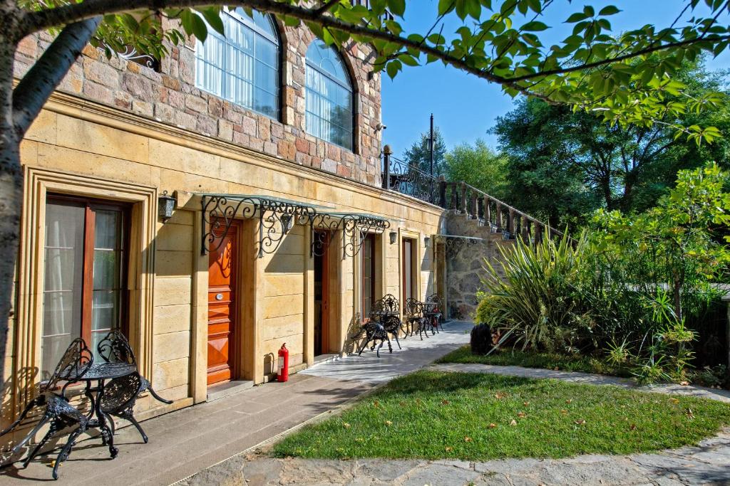 a building with benches sitting outside of it at Wineport Lodge Agva Riverside Hotel & Winery in Ağva