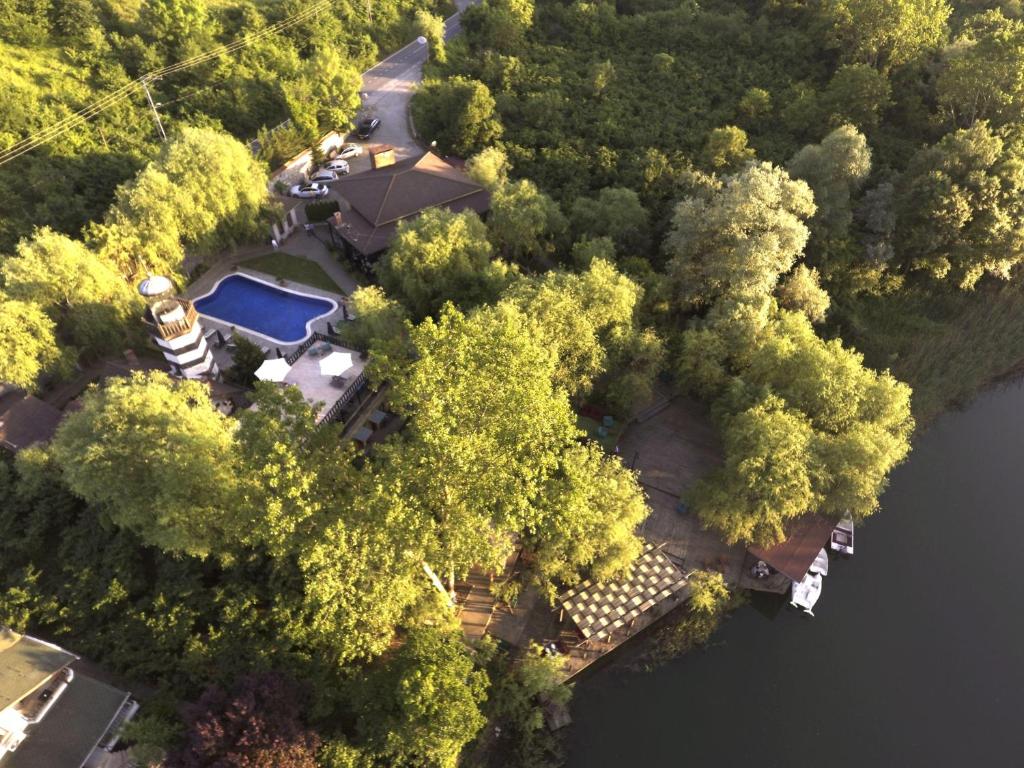 an overhead view of a house with a swimming pool and trees at Wineport Lodge Agva Riverside Hotel & Winery in Ağva
