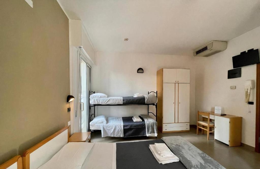 Postel nebo postele na pokoji v ubytování Hotel Quisisana