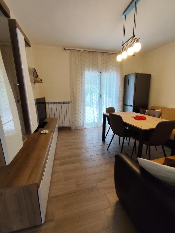 a living room with a table and a dining room at Casa Milona in Castelveccana