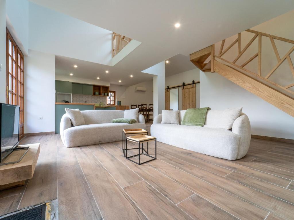 un salon avec deux canapés et une télévision dans l'établissement Pontenx-les-Forges : Maison 8p avec Jardin et Climatisation - FR-1-50-164, à Pontenx-les-Forges