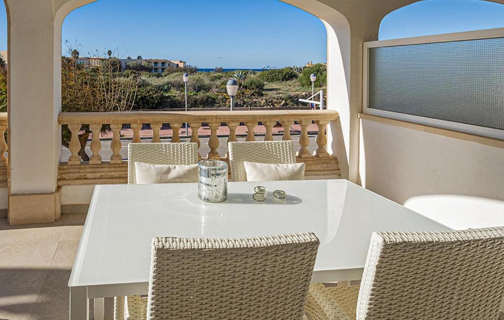 a white table and chairs on a balcony at Primavera in Colònia De Sant Jordi