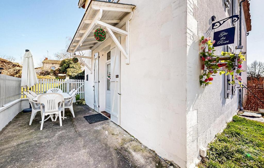 a patio with a table and chairs next to a building at 2 Bedroom Cozy Home In Oradour-Fanais in Oradour-Fanais
