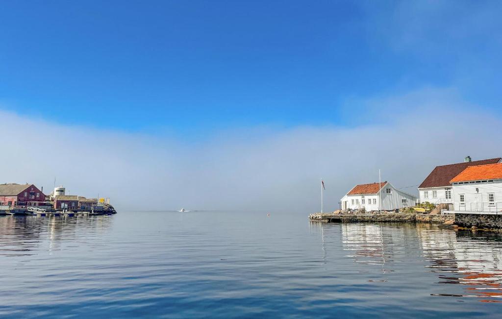 a group of houses on a dock in the water at 3 Bedroom Awesome Apartment In Søgne in Søgne