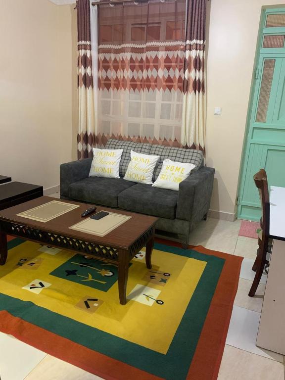 a living room with a couch and a coffee table at Angie's Nest in Syokimau