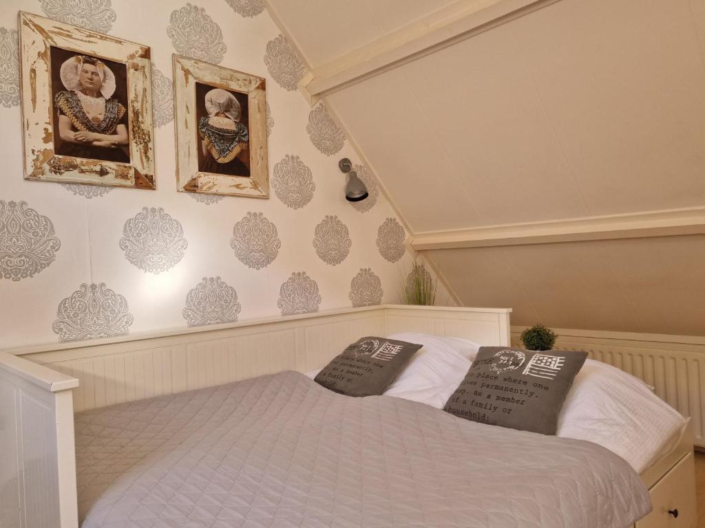 a bedroom with a bed with two pillows on it at VakantieStudio 88 in Kamperland