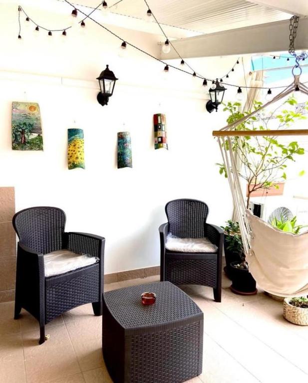 a patio with chairs and a table and lights at Dimora Criosa b&b in Ruvo di Puglia