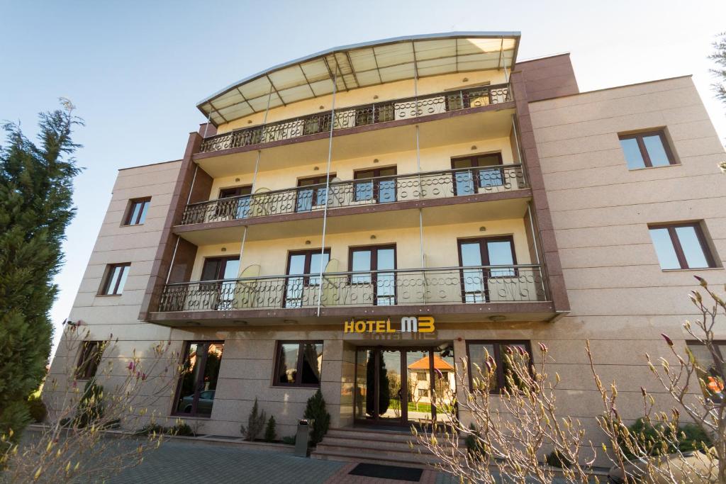 a hotel with a large building with a balcony at Hotel M3 in Sarajevo