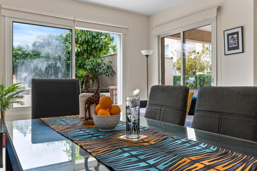 a dining room with a table with oranges on it at A Piece of Africa in Mandria by VICHY Holidays in Paphos