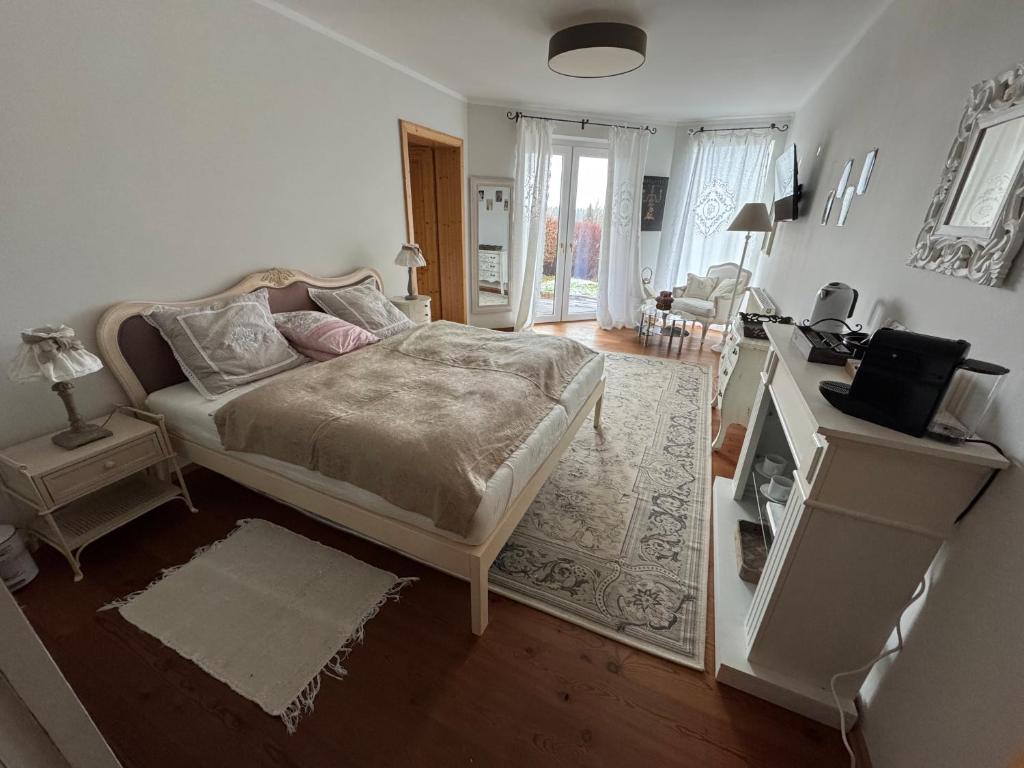 a bedroom with a bed and a desk with a television at Spa&Golf-Suite Velden in Velden am Wörthersee