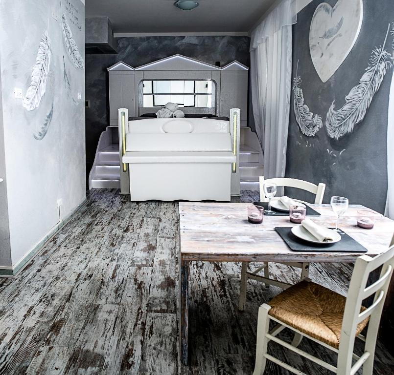 a bedroom with a bed and a table and chairs at Hotel Butterfly in Torre del Lago Puccini