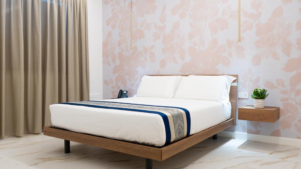 Postel nebo postele na pokoji v ubytování Hotel Diana