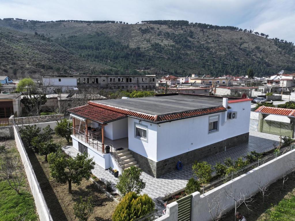 a white house with a mountain in the background at Lana's House in Berat