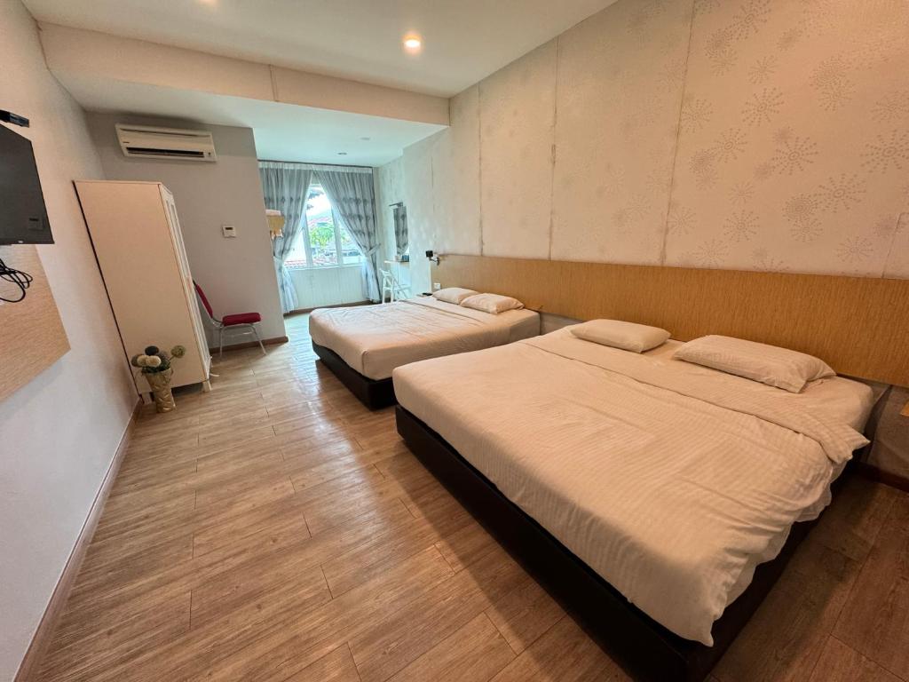 a hotel room with two beds in a room at Tropical villa in Kuantan