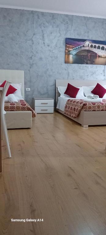 two beds in a room with wooden floors at Ca Felisati Venice in Mestre