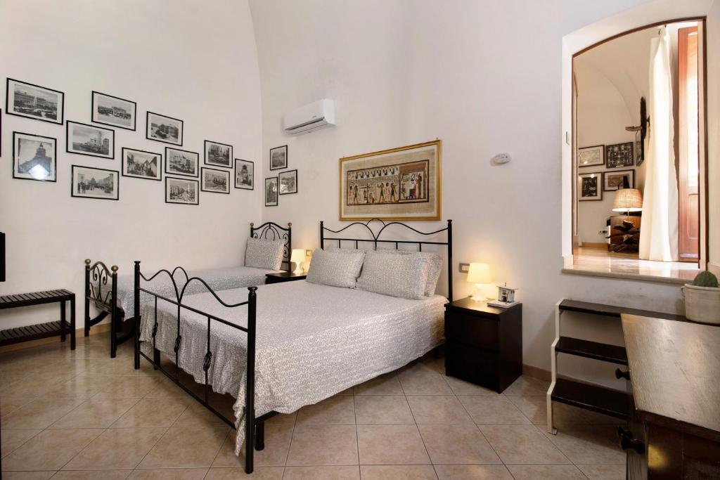 a bedroom with a bed and pictures on the wall at Home Sweet Home in Giovinazzo
