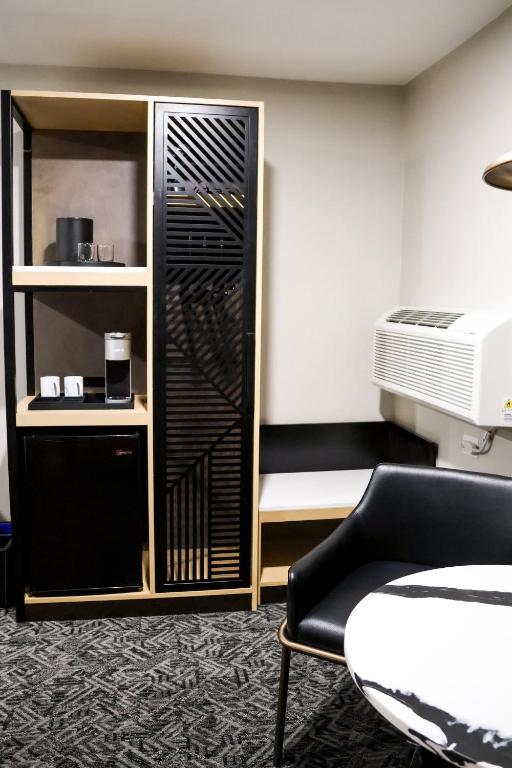 a room with a chair and a closet at voco Flagstaff by IHG in Flagstaff