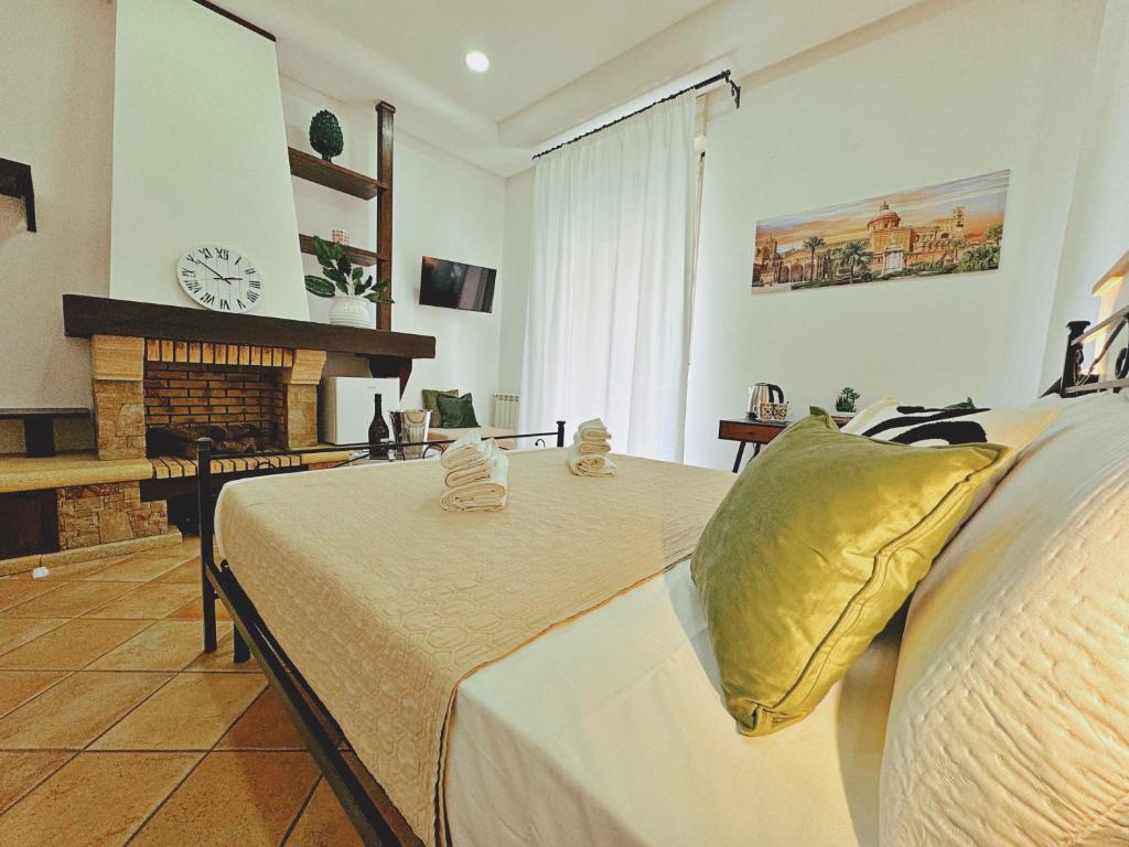 a large bedroom with a bed and a fireplace at Sicania - In centro Storico a Palermo in Palermo