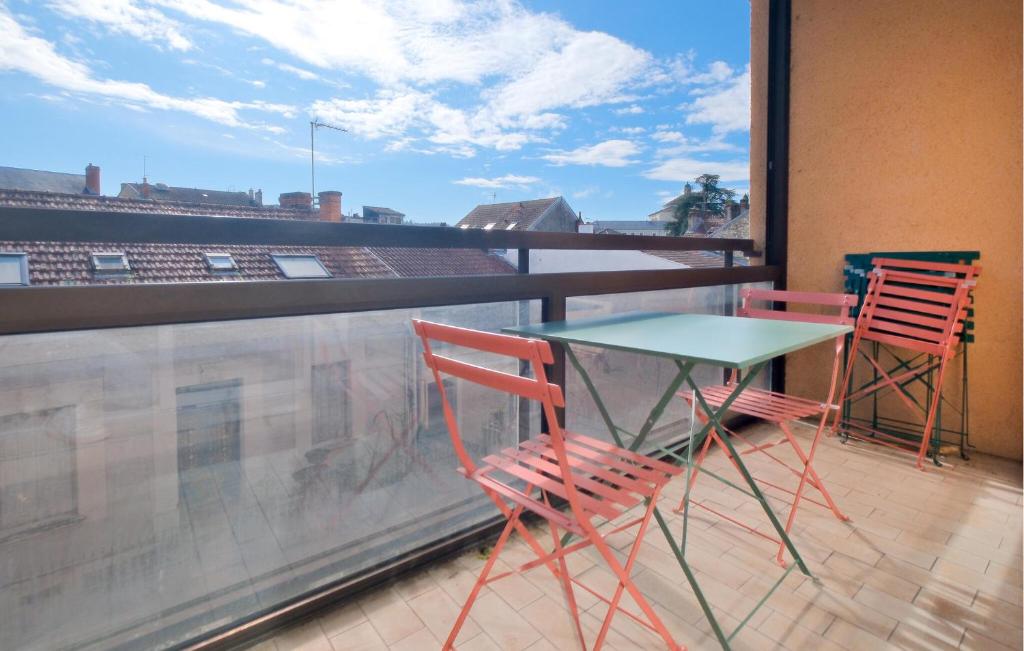 a table and chairs on a balcony with a view at 4 Bedroom Cozy Apartment In Périgueux in Périgueux