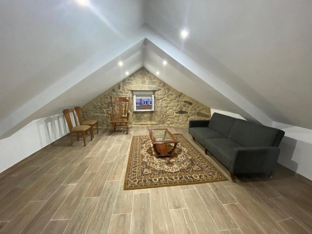 a living room with a couch and a table at Casa de Ferreñas-5 dormitorios in Esteiro