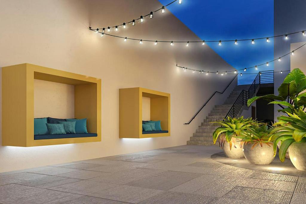 a room with two beds and a staircase with lights at Fairfield by Marriott San Jose Airport Alajuela in Alajuela City