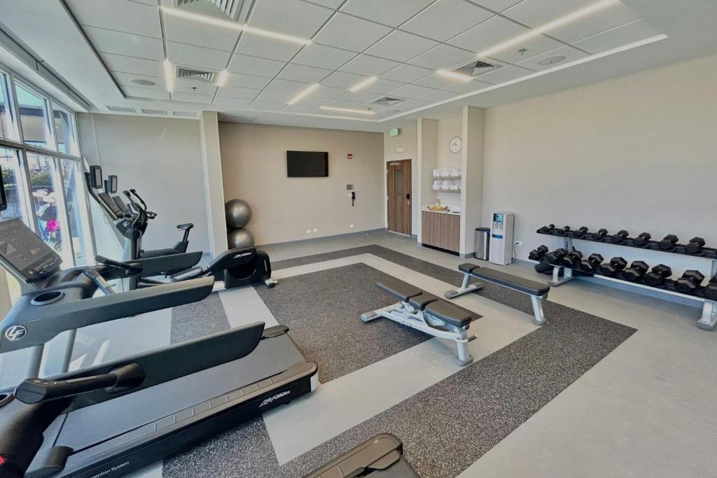 a gym with two treadmills and two exercise bikes at Fairfield by Marriott San Jose Airport Alajuela in Alajuela City
