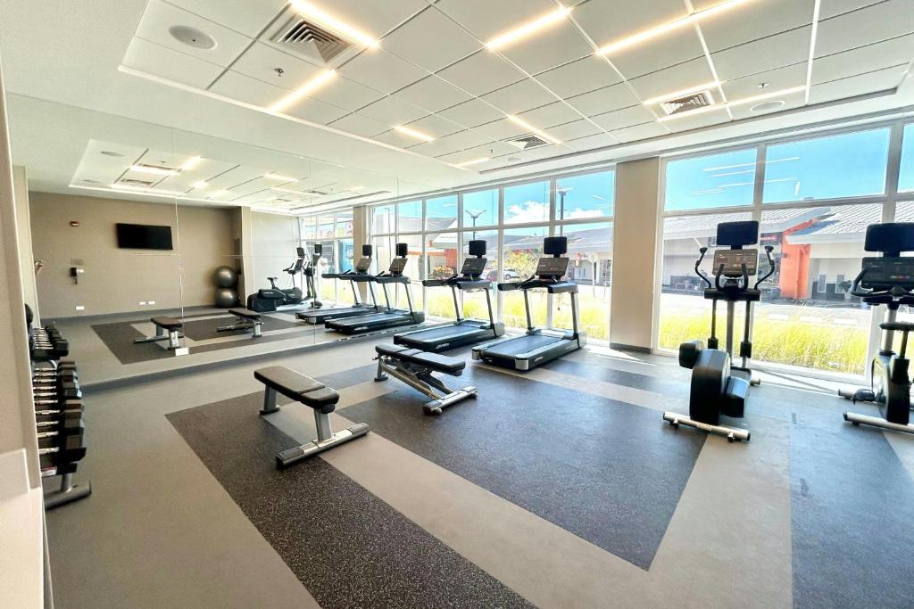 a gym with several treadmills and cardio machines at Fairfield by Marriott San Jose Airport Alajuela in Alajuela City