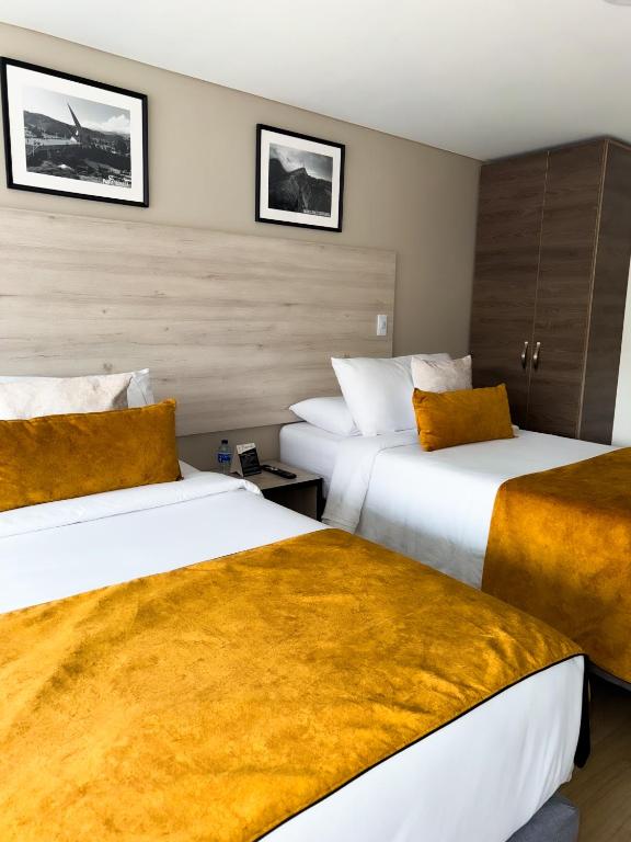 Postel nebo postele na pokoji v ubytování Hotel WLH Gold Bogota