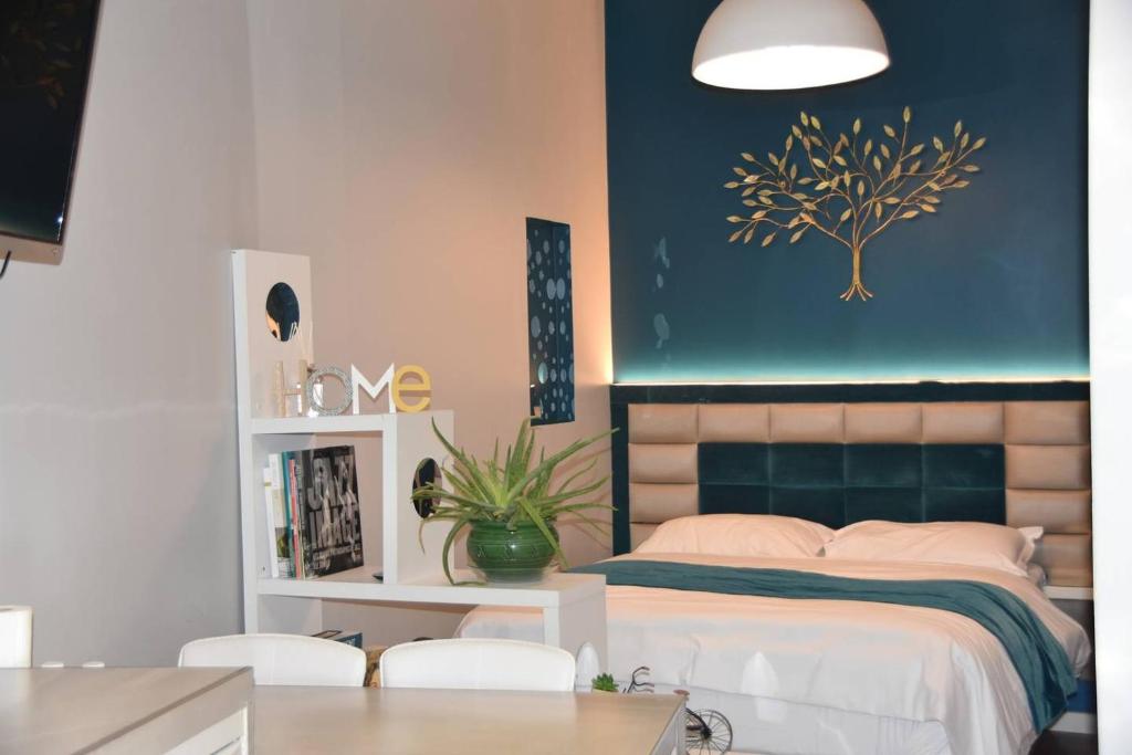 a bedroom with a bed with a tree on the wall at Home in Paris Eiffel Tower & Champs Elysees in Paris