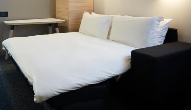 Postel nebo postele na pokoji v ubytování Hôtel Escad Quartier DIX30