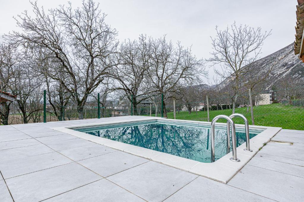 a swimming pool in the middle of a patio at La maison dans les noyer in Sainte-Eulalie