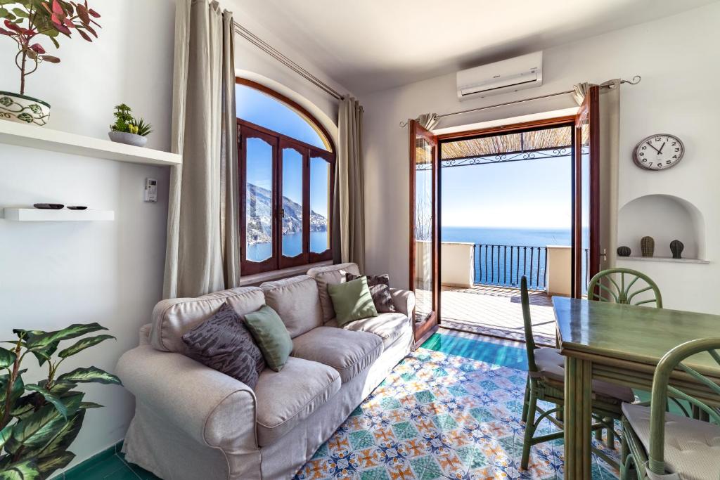a living room with a couch and a table at Villa Panorama in Positano