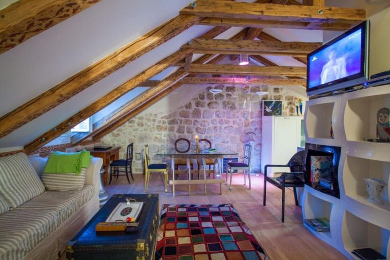 a living room with a couch and a tv at Apartman Dominus in Dubrovnik