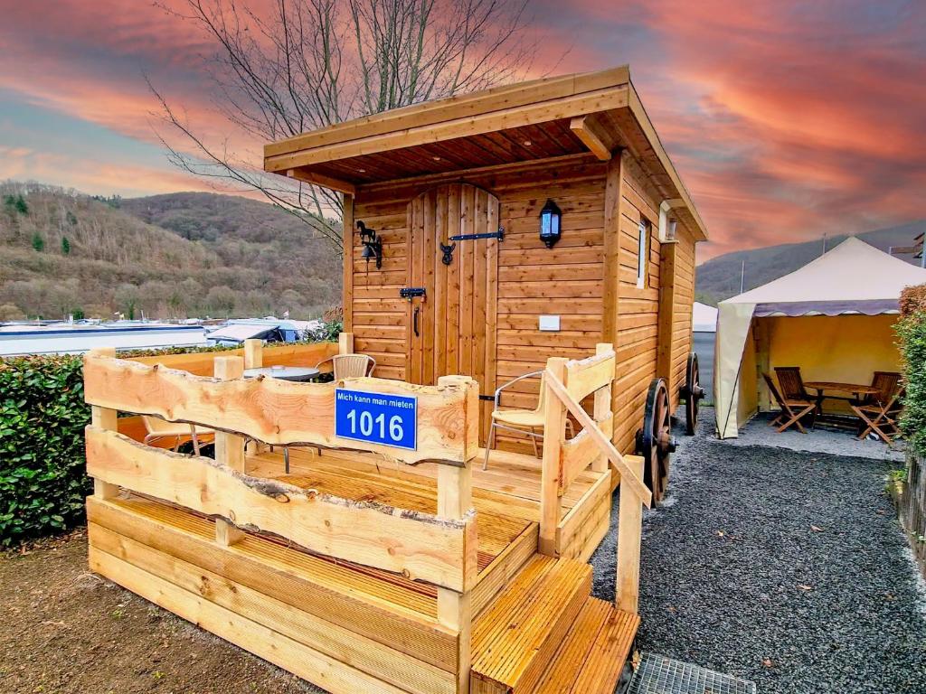 a wooden out house with a fence in front at Nideggener Burgwagen 1016 in Nideggen