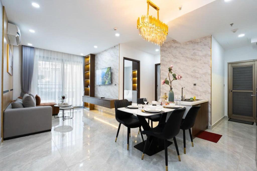 a dining room and living room with a table and chairs at StayX Condotel in Ho Chi Minh City