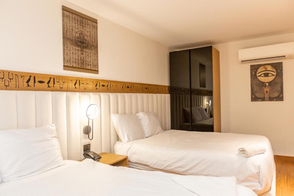 Postel nebo postele na pokoji v ubytování Superior Pyramids Inn